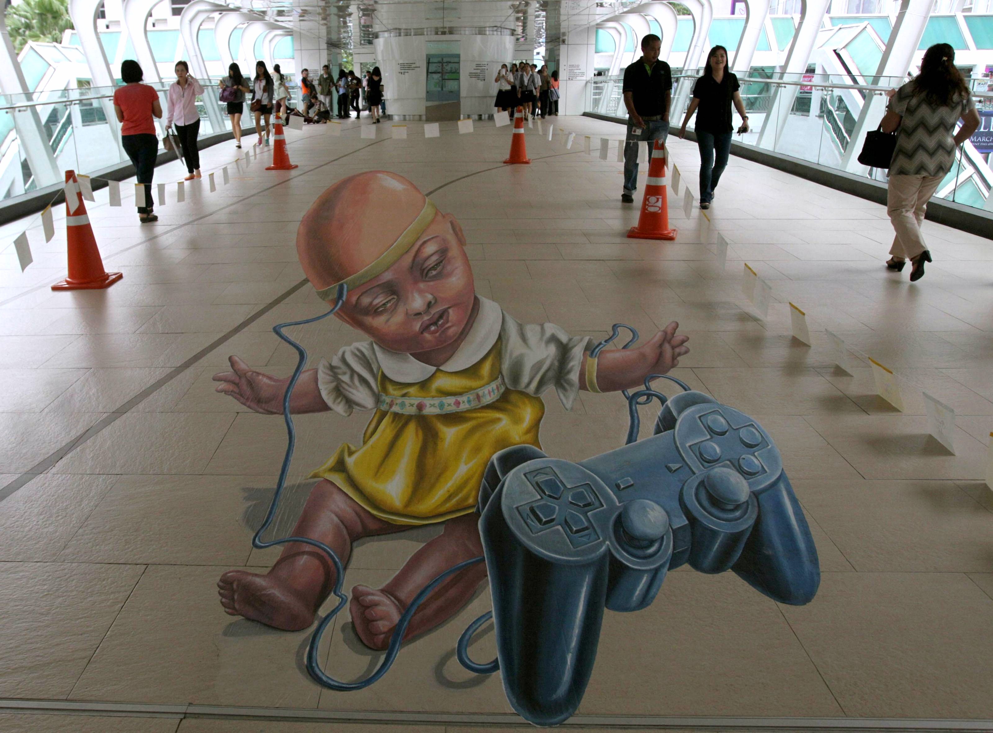 Thai people walk beside a 3D street painting entitled “Victim of Circumstance” by the Netherlands' Leon Keer during ... - Изображение 1 Thai people walk beside a 3D street painting entitled “Victim of Circumstance” by the Netherlands' Leon Keer during ... - Изображение 1